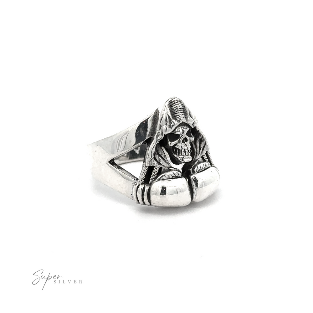 A .925 Sterling Silver ring featuring a detailed skull cloaked in a hooded robe, sitting atop a band with intricate designs. This Grim Reaper With Boxing Gloves Ring is marked "Super Silver" in the bottom left corner.
