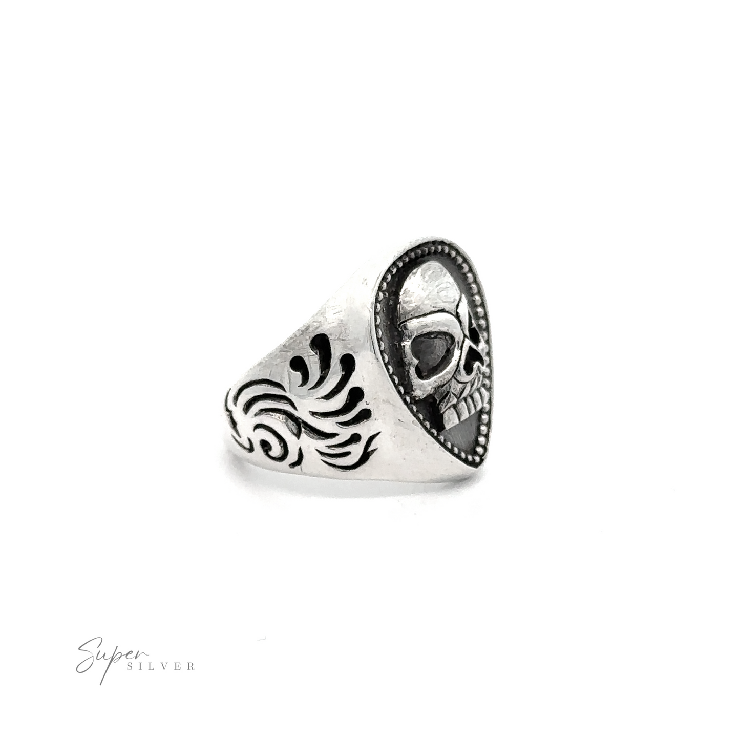 
                  
                    A heavy silver ring featuring a guitar pick-shaped face with an engraved skull design on a black background and a decorative pattern on the side, the Guitar Pick Skull Ring.
                  
                