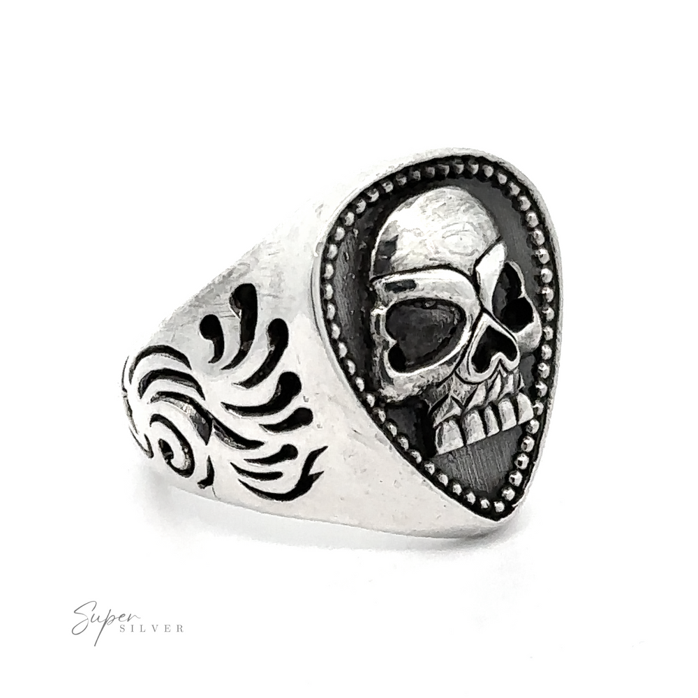 A heavy Guitar Pick Skull Ring featuring a guitar pick-shaped face adorned with a skull design on the front and intricate, flame-like carvings on the sides. The inscription "Super Silver" is visible on the bottom left.