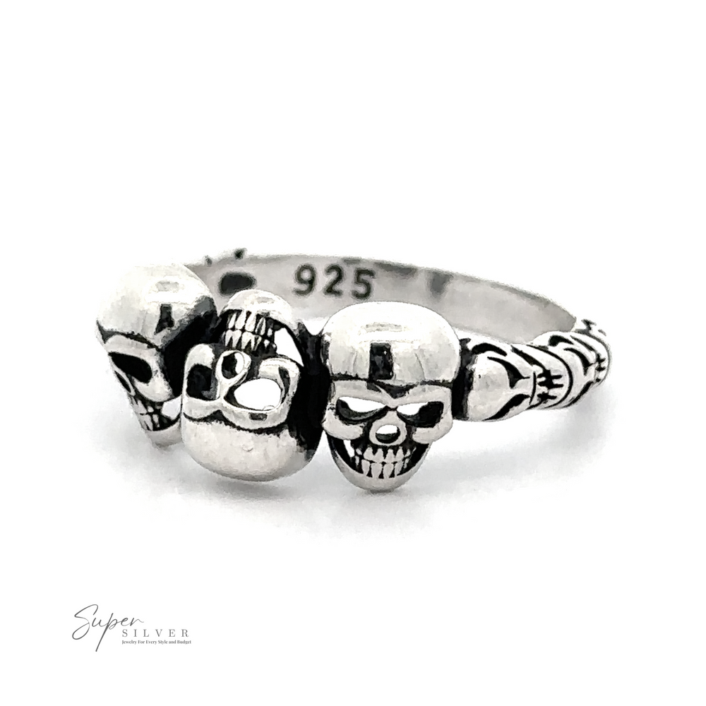 
                  
                    A Three Skulls Ring featuring three skull designs, with the hallmark ".925 Silver" indicating silver purity. The background is plain white.
                  
                