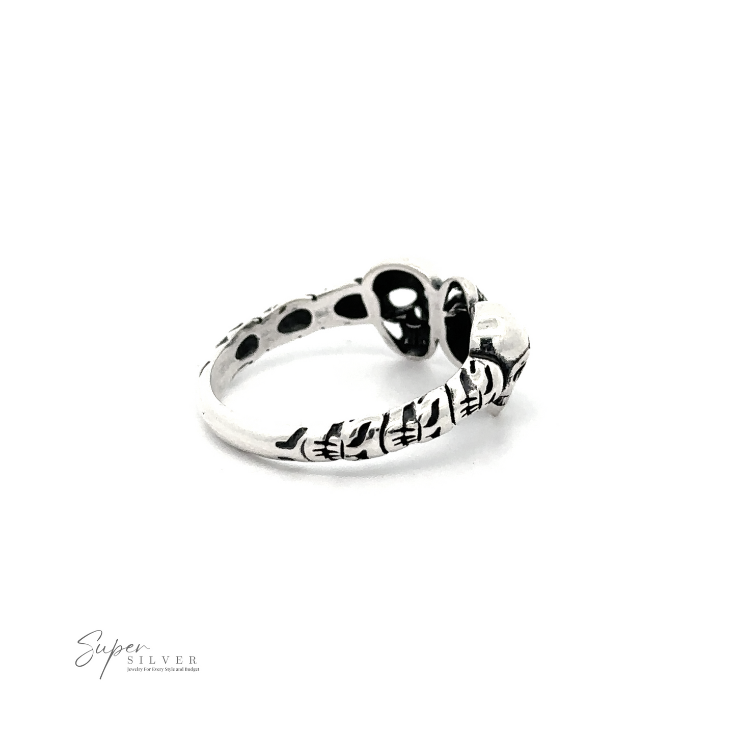 
                  
                    Three Skulls Ring with black skull design and engraved patterns against a white background.
                  
                