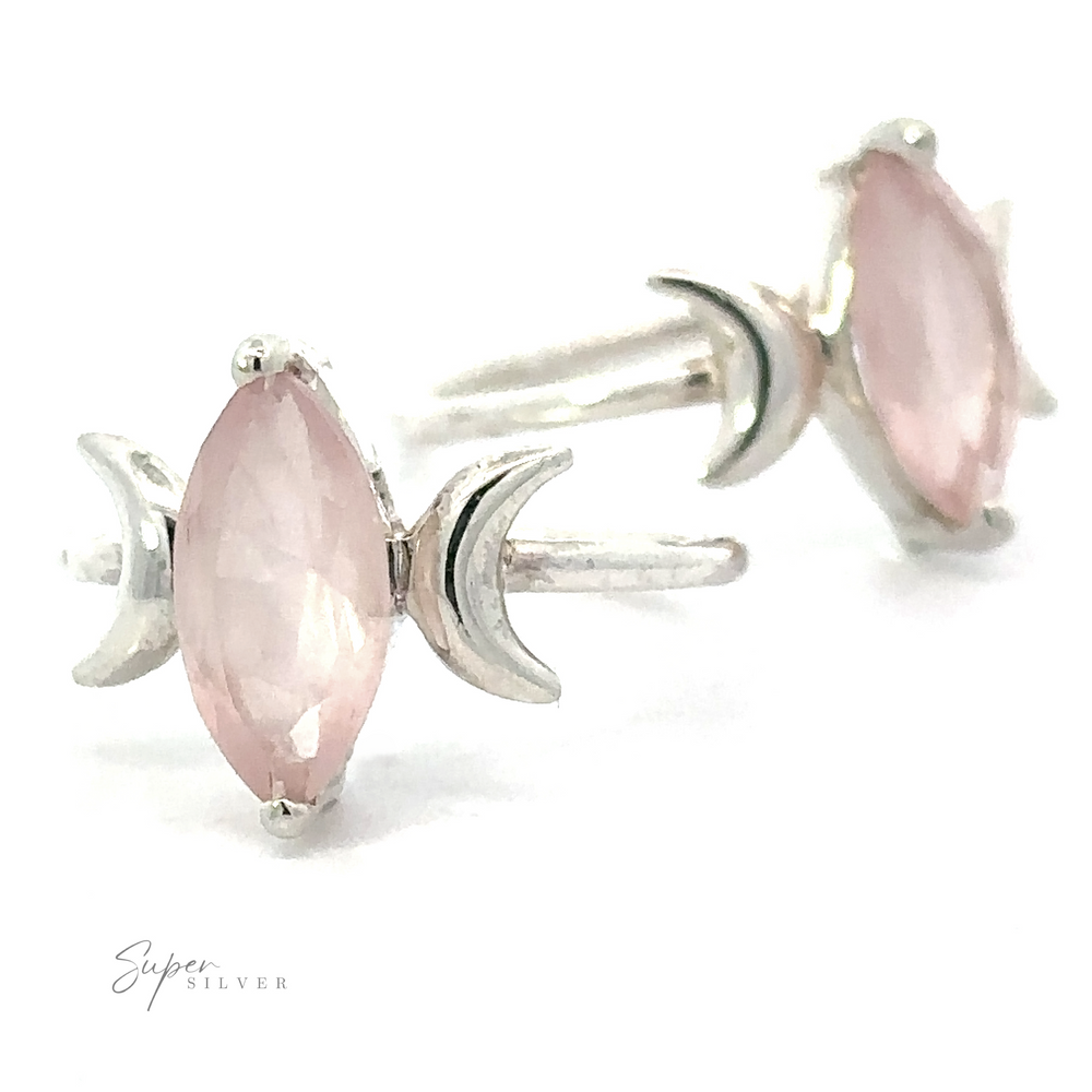 A pair of rose quartz crescent moon rings, designed to resemble flowers, on a white background.