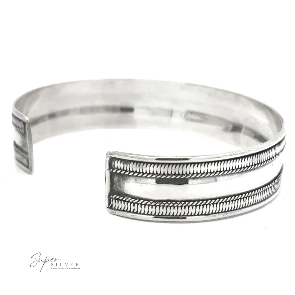 A polished, Silver Cuff Bracelet with a double parallel line design featuring a ribbed texture. Crafted from .925 sterling silver, the brand name "Super Silver" is inscribed in the bottom left corner.
