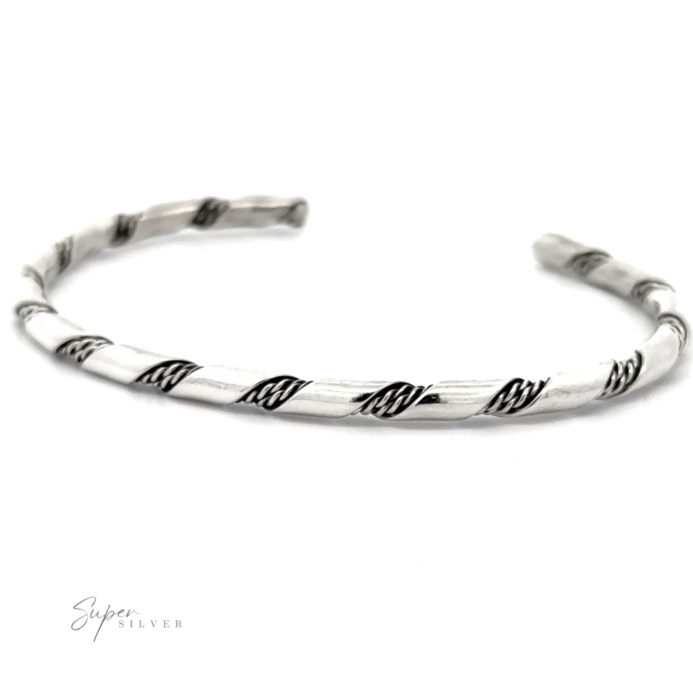 
                  
                    A delicate Native American Handmade Thin Silver Twist Cuff with an open cuff design displayed against a white background. The bracelet has black accents along the twists, perfect for stacking with other pieces.
                  
                