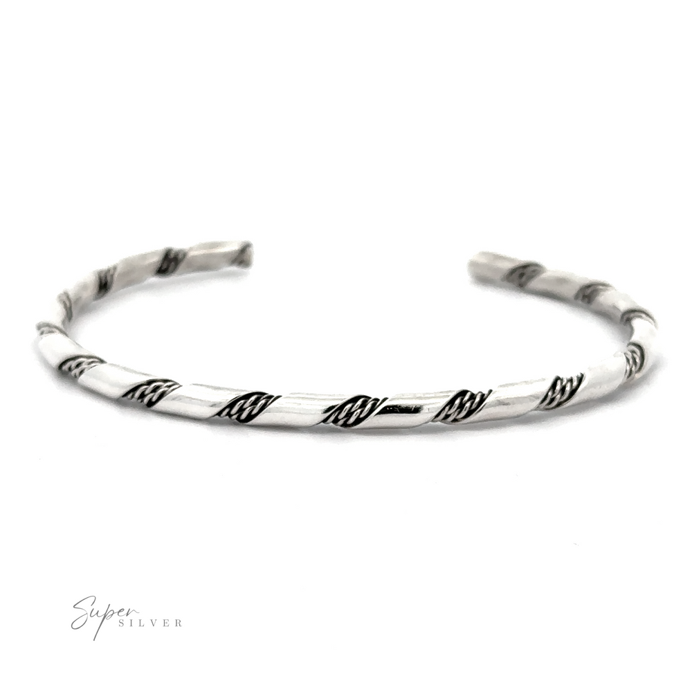 
                  
                    A delicate Native American Handmade Thin Silver Twist Cuff with twisted black accents, showcasing an open design with tapered ends, placed against a white background. The "Super Silver" logo is visible in the bottom-left corner, perfect for stacking.
                  
                