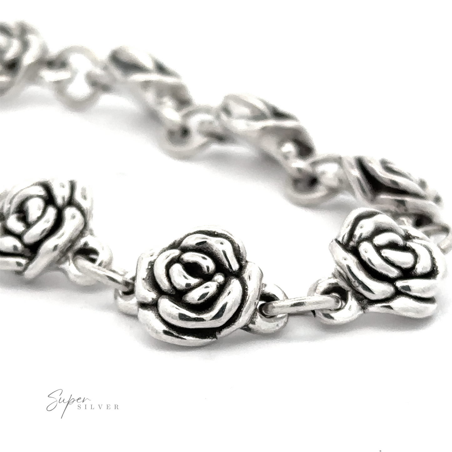 
                  
                    Close-up image of a Chic Link Rose Bracelet featuring intricately designed rose-shaped links, giving it a vintage vibe. The brand name "Super Silver" is seen in the bottom left corner, highlighting its .925 Sterling Silver quality.
                  
                