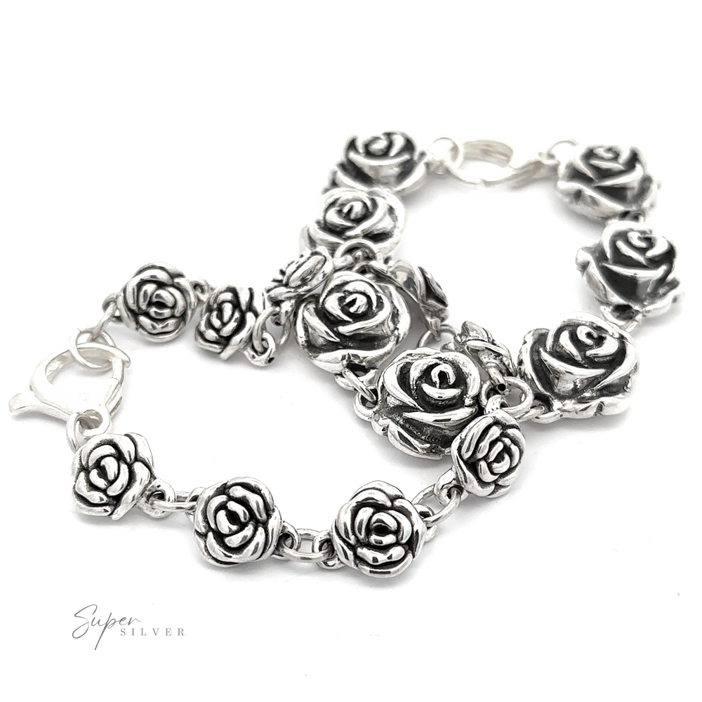 A Chic Link Rose Bracelet adorned with rose-shaped charms, featuring a lobster clasp. Background is white, giving off a vintage vibe.