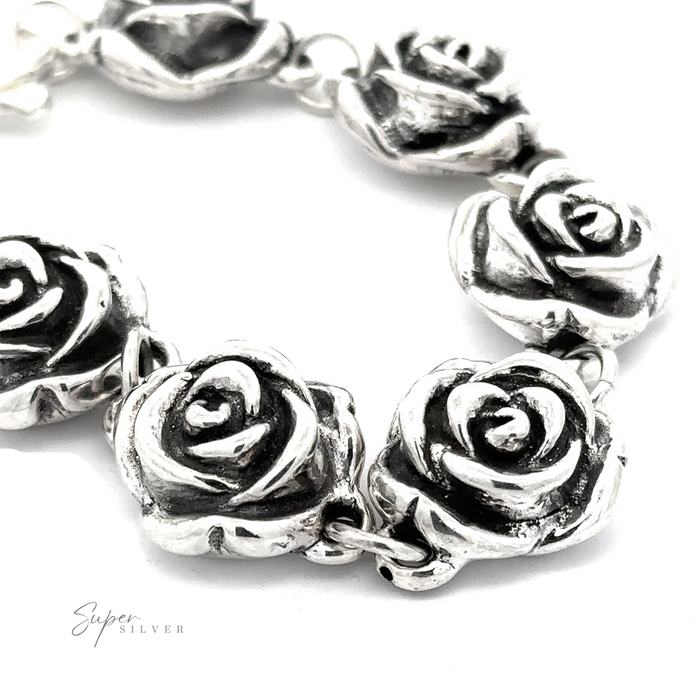 
                  
                    Close-up of a Chic Link Rose Bracelet featuring intricately shaped rose designs. The bracelet exudes a vintage vibe, emphasizing the detailed craftsmanship of the floral elements. Sign reads "Super Silver".
                  
                
