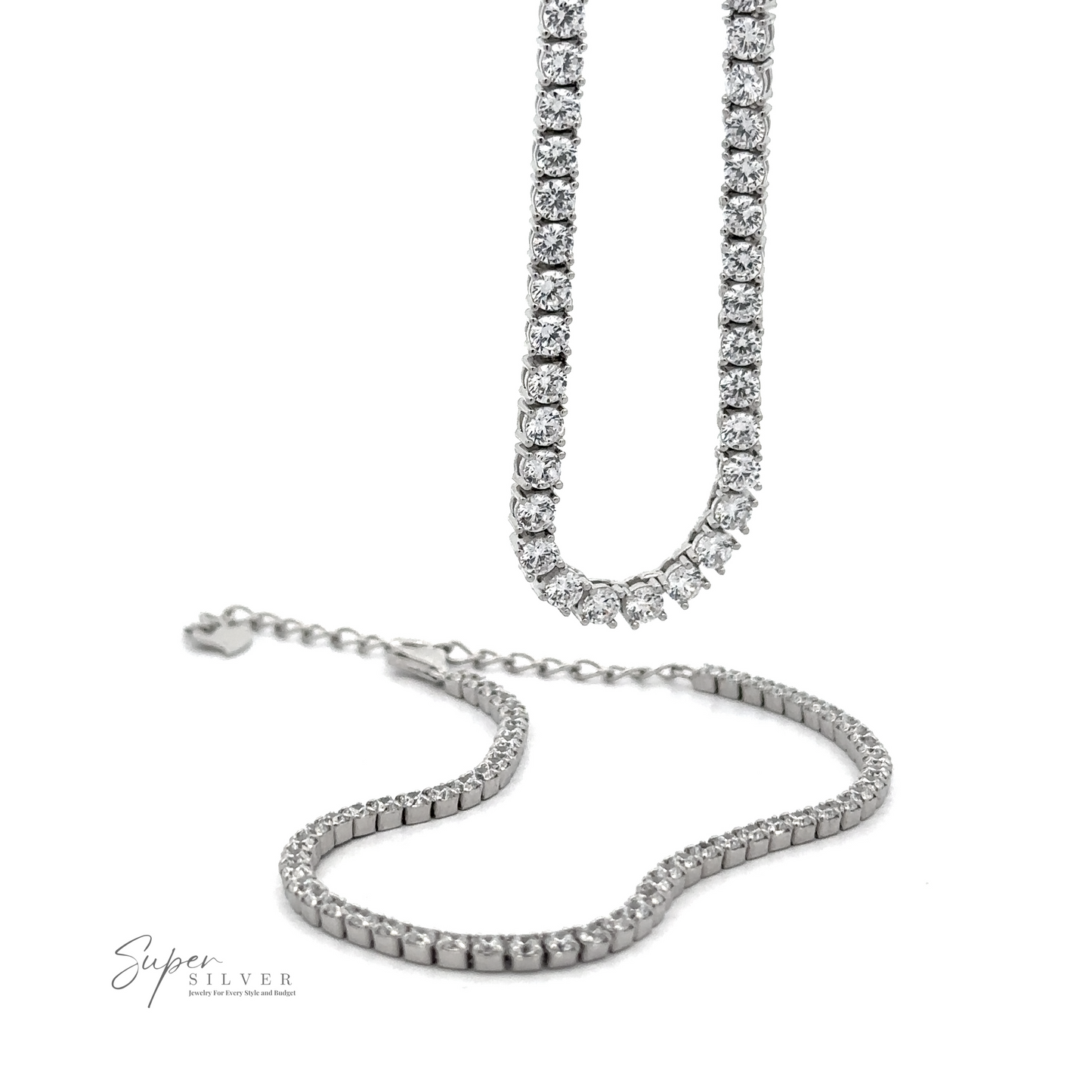 
                  
                    Two Cubic Zirconia Tennis Necklaces adorned with small, round diamonds; one is extended vertically, while the other lies horizontally on a white surface. Made from 925 Sterling Silver and featuring the "Super Silver" logo in the bottom left.
                  
                