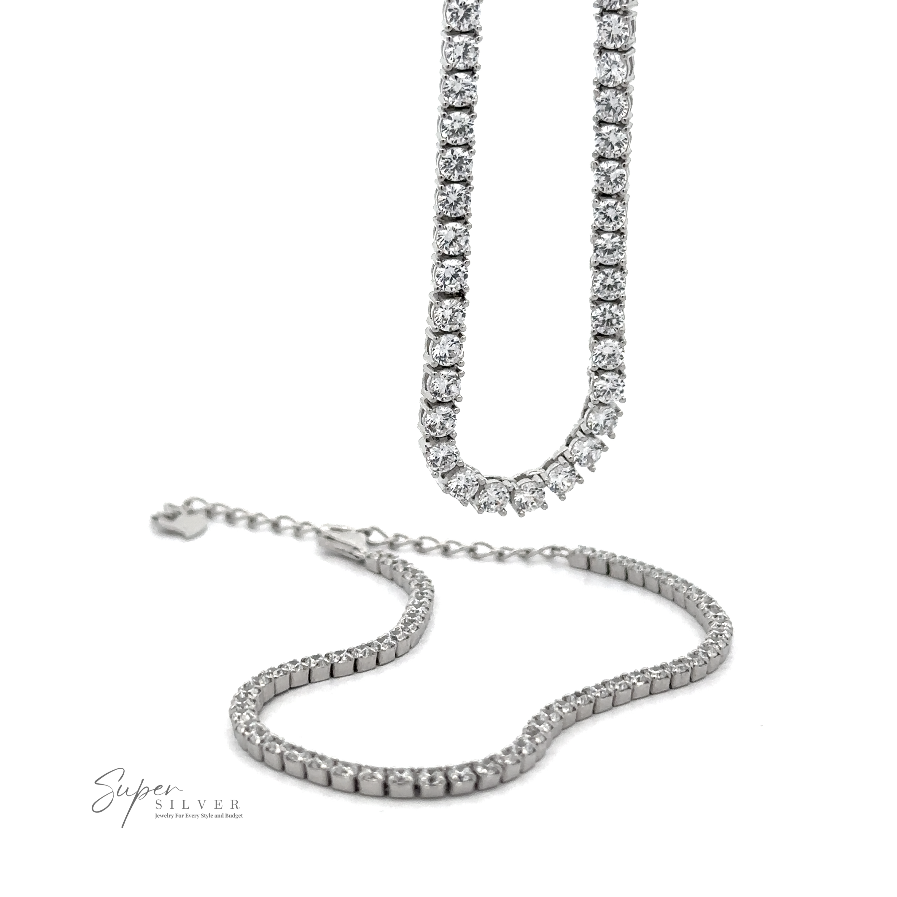 Two Cubic Zirconia Tennis Necklaces adorned with small, round diamonds; one is extended vertically, while the other lies horizontally on a white surface. Made from 925 Sterling Silver and featuring the "Super Silver" logo in the bottom left.