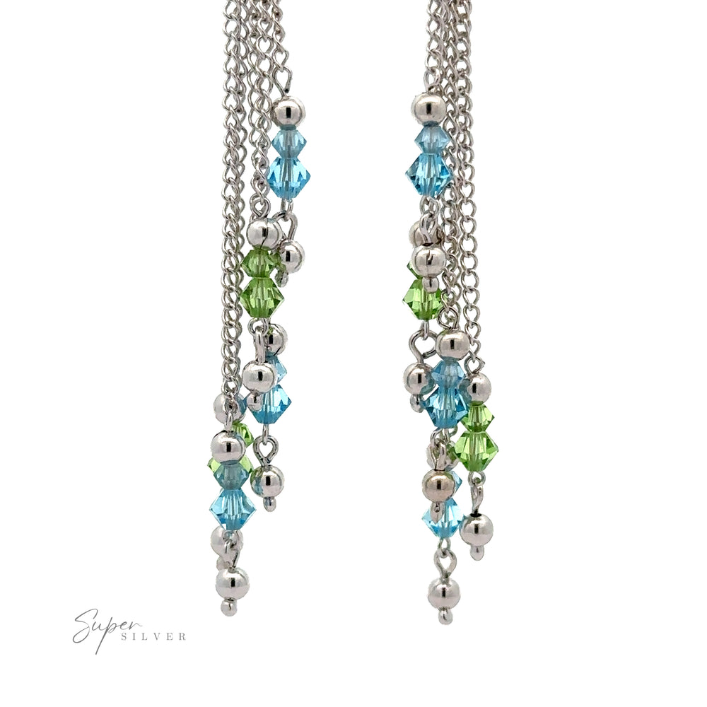 
                  
                    A pair of Layered Earrings with Multicolored Beads featuring silver chains and clustered light blue and green multicolored beads, accented by small silver spheres, all crafted from rhodium-plated sterling silver. Set against a white background.
                  
                