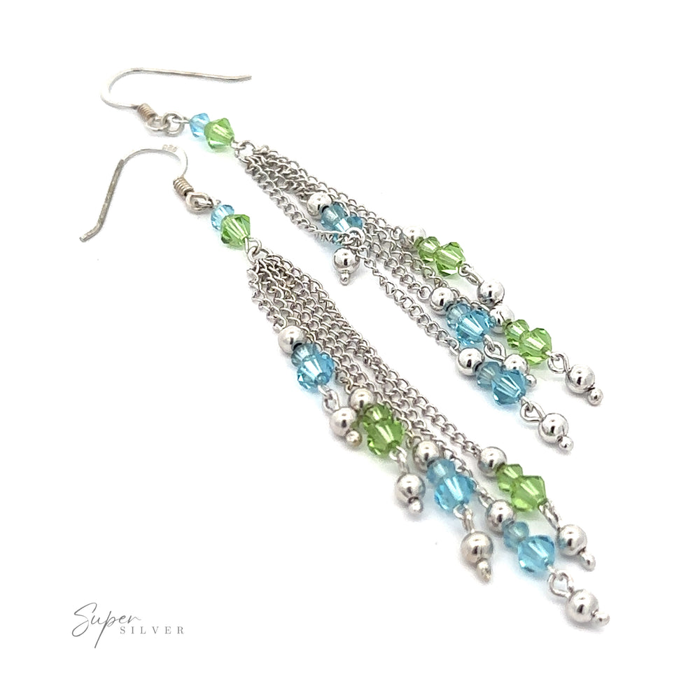 
                  
                    A pair of Layered Earrings with Multicolored Beads, crafted from rhodium-plated sterling silver, featuring delicate chains adorned with small multicolored beads in blue, green, and silver.
                  
                