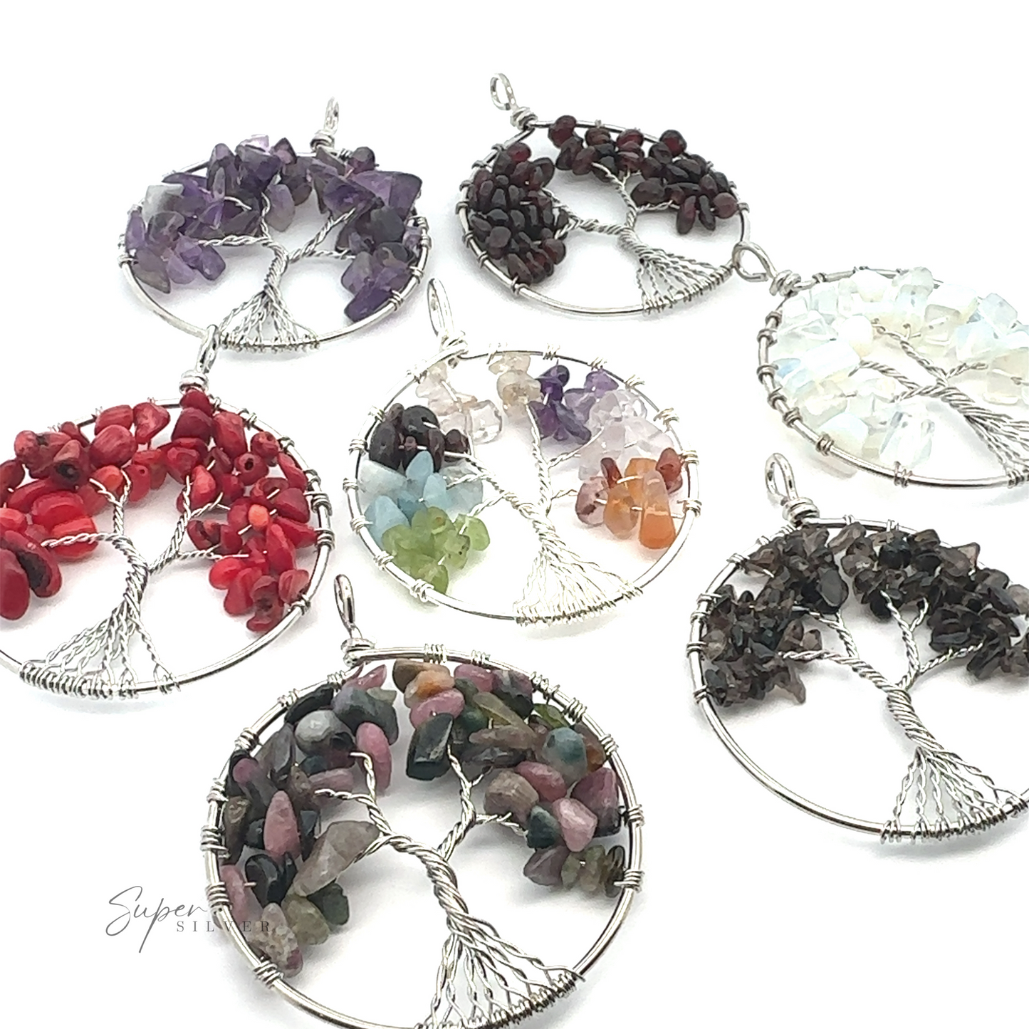 A group of Wire Wrapped Tree of Life Pendants crafted with mixed metals and adorned with different colored gemstones.