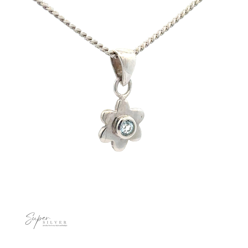 
                  
                    A silver necklace with a Tiny Gemstone Flower Pendant featuring a small gemstone in the center. This exquisite piece of sterling silver jewelry is from Super Silver.
                  
                