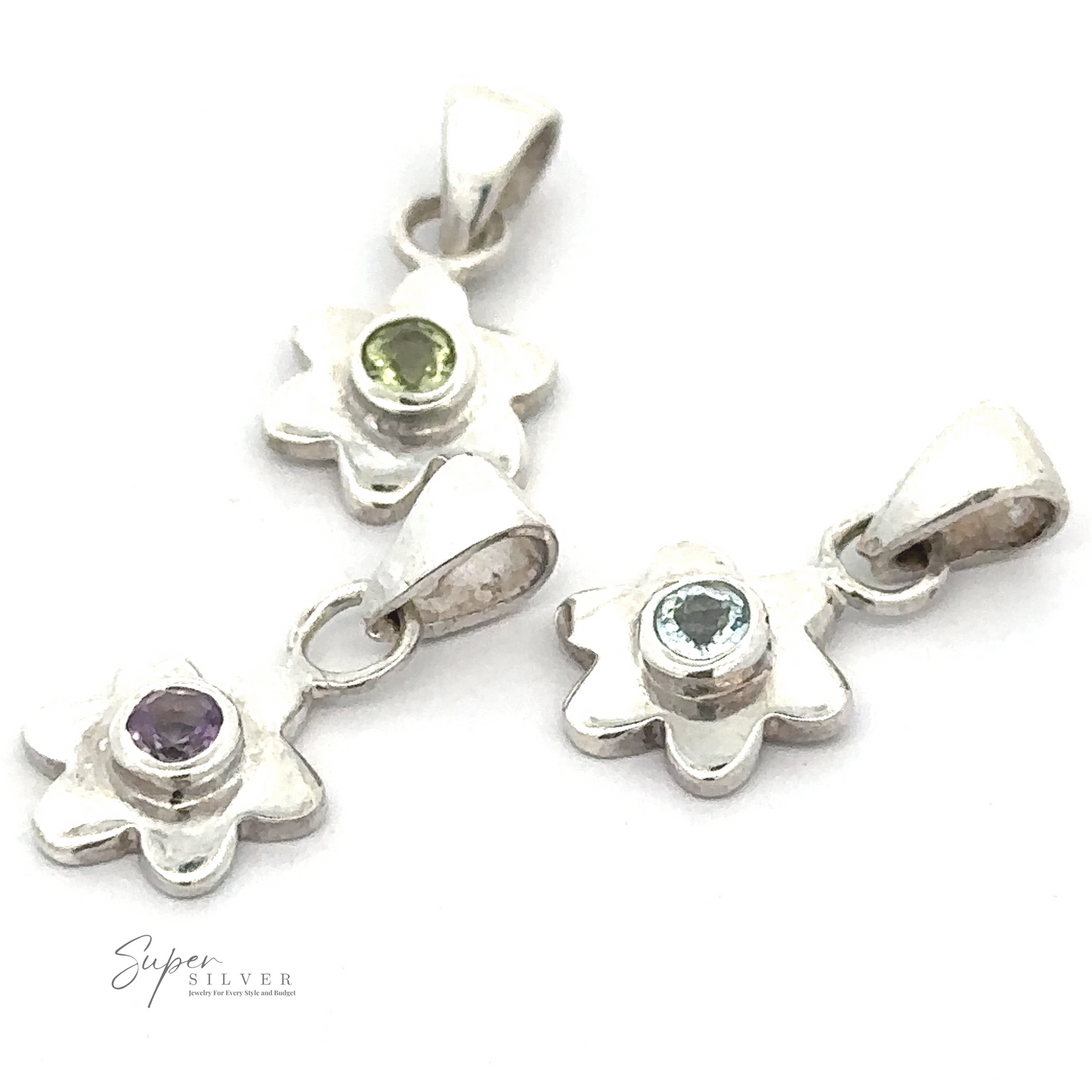 
                  
                    Three Tiny Gemstone Flower Pendants, each with a unique gemstone center, arranged on a white background. The gemstones are purple, light green, and light blue.
                  
                
