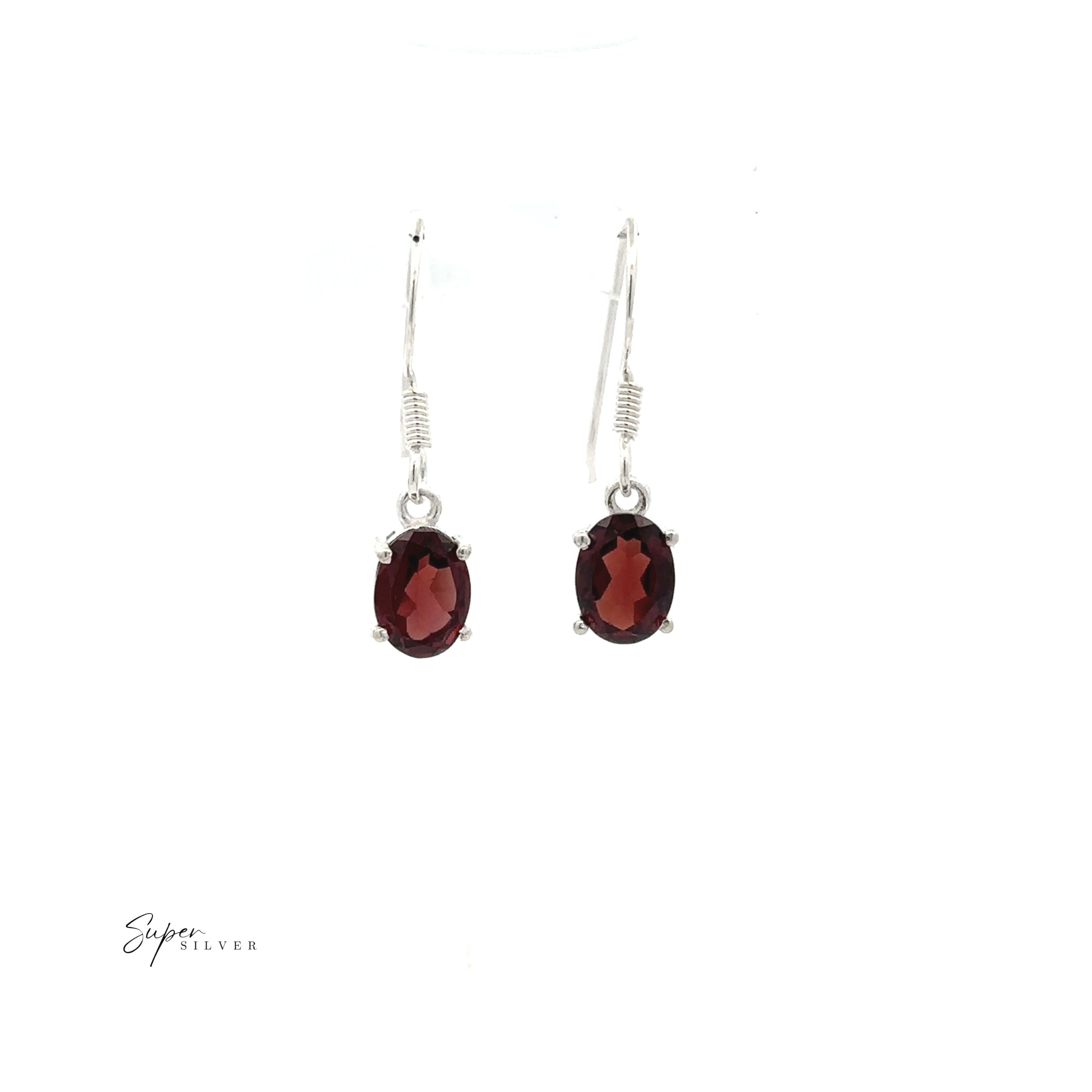 The Brilliant Oval Gemstone Earrings feature sterling silver and deep red oval-shaped gemstones, shown against a white background.