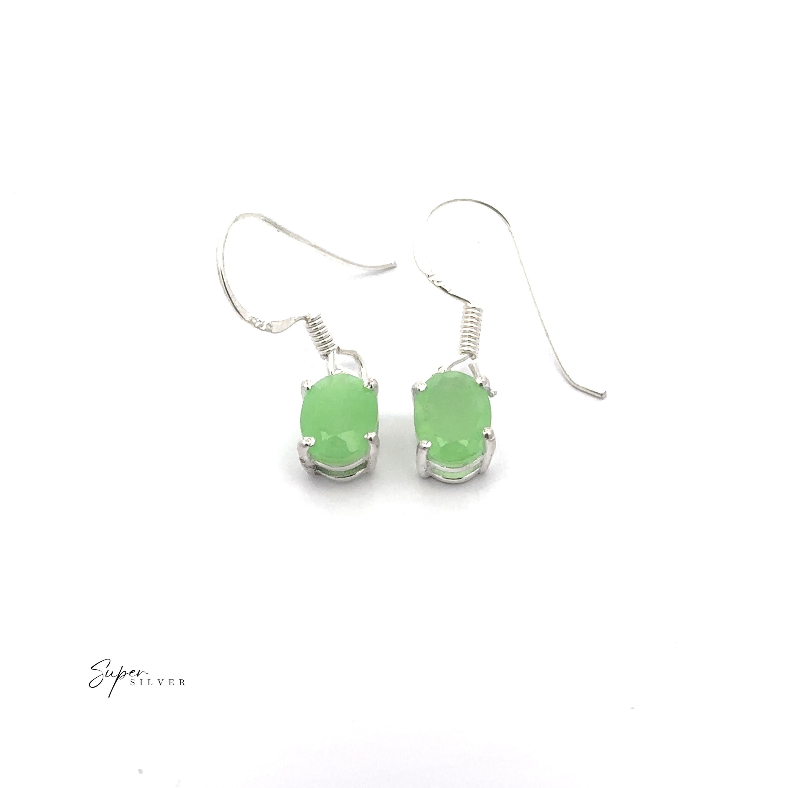 Brilliant Oval Gemstone Earrings: Sterling silver hook earrings featuring prong-set oval green gemstones, shown on a white background.