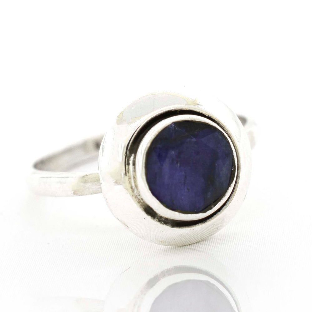
                  
                    A Round Gemstone Ring With Oxidized Outline with a blue sapphire stone.
                  
                