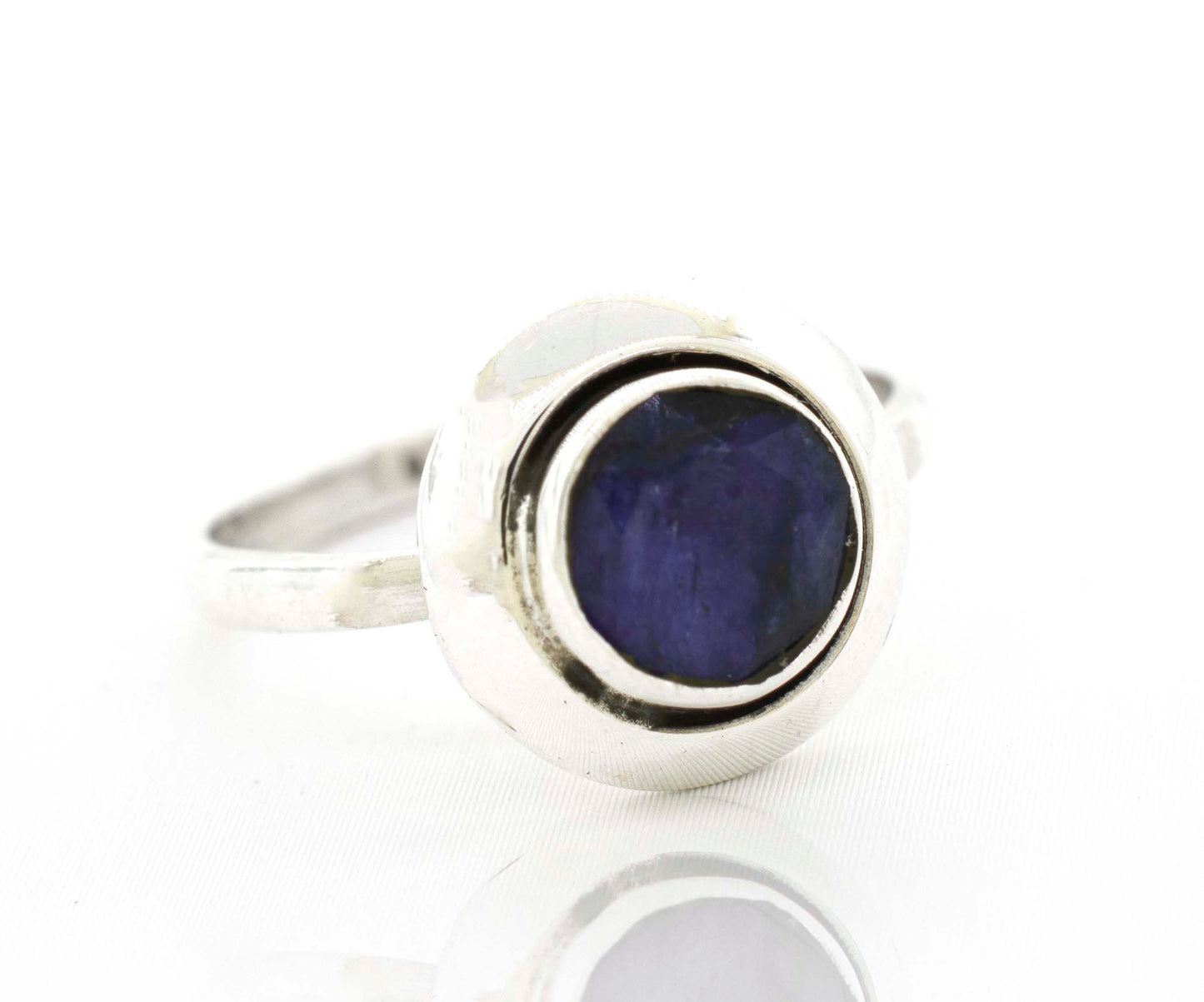 
                  
                    A Round Gemstone Ring With Oxidized Outline with a blue sapphire stone.
                  
                