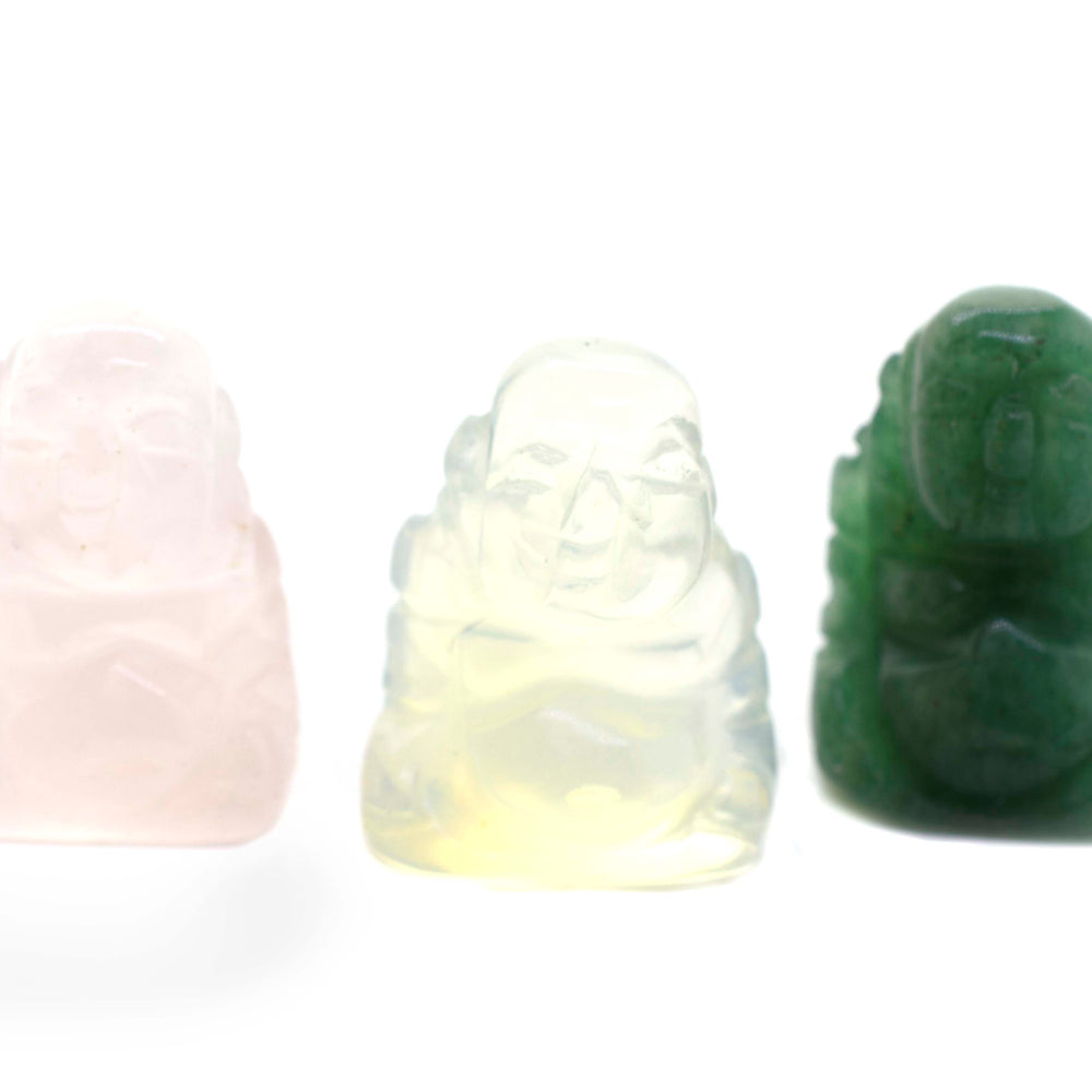 Three Laughing Buddha Gemstone Figures made of jade on a white background.