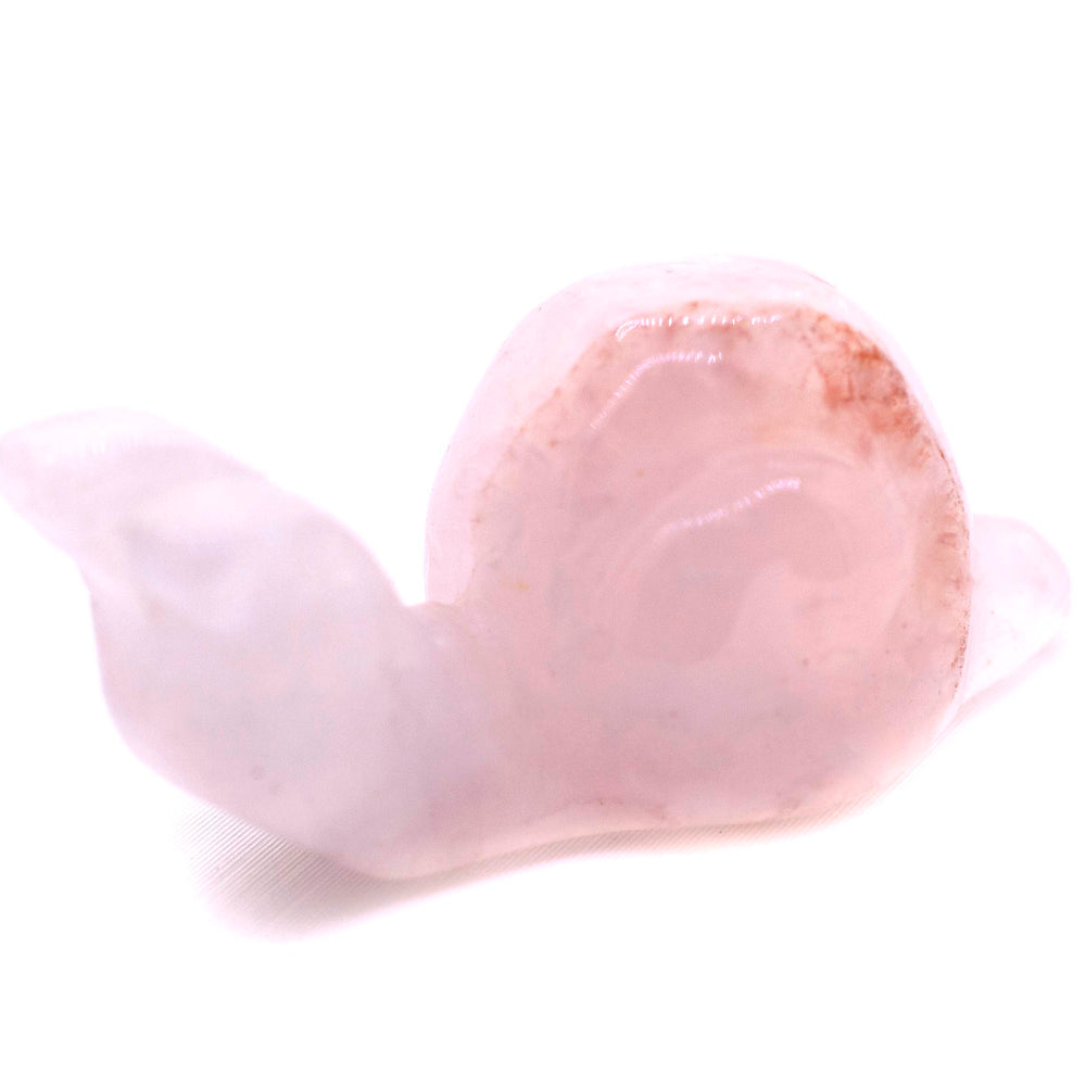 
                  
                    A small pink Snail Carved Gemstone Figure sitting on a white surface, perfect as a decor accent.
                  
                