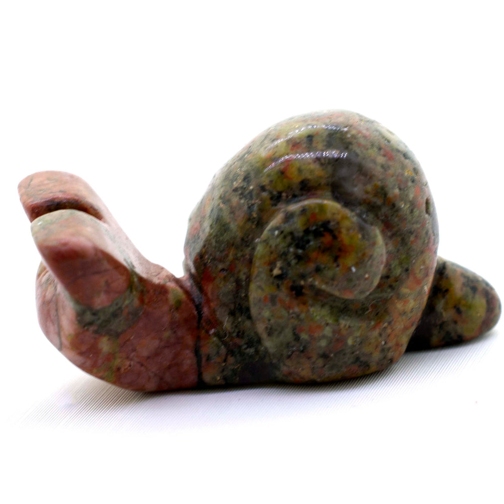 
                  
                    A Snail Carved Gemstone Figure on a white background.
                  
                