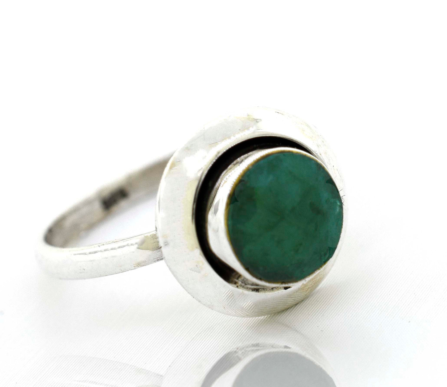 A boho-inspired Round Gemstone Ring With Oxidized Outline with an emerald stone.