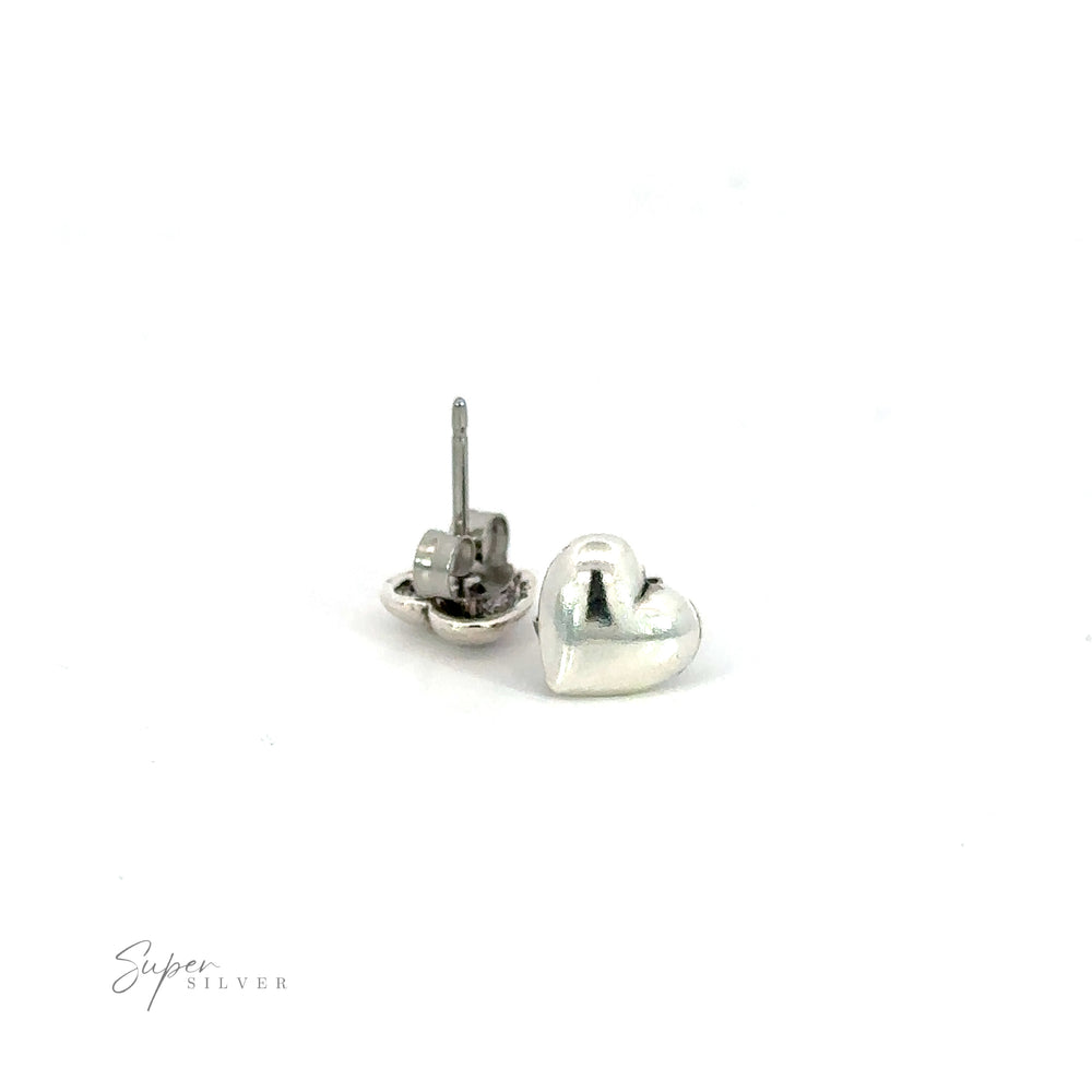 A pair of Simple Heart Studs on a white background, symbolizing love.