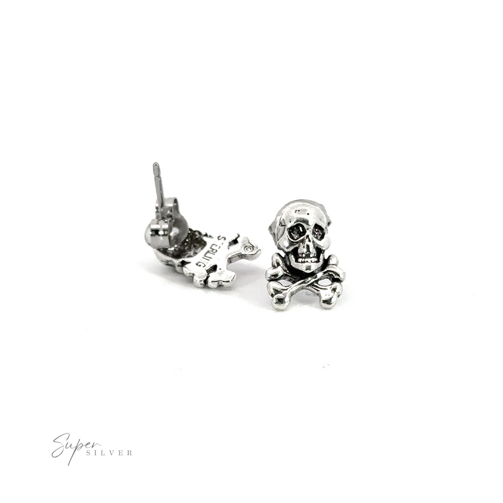 An edgy pair of Skull and Crossbones Studs crafted from .925 sterling silver, showcased against a clean white background.