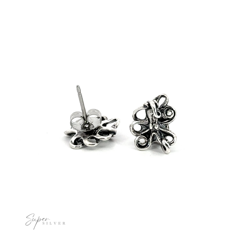 A pair of silver Intricate Octopus Studs on a white background.