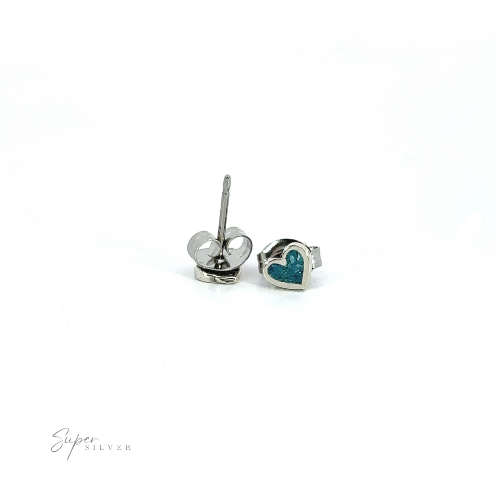 A pair of Tiny Turquoise Heart Studs with inlaid turquoise stones.