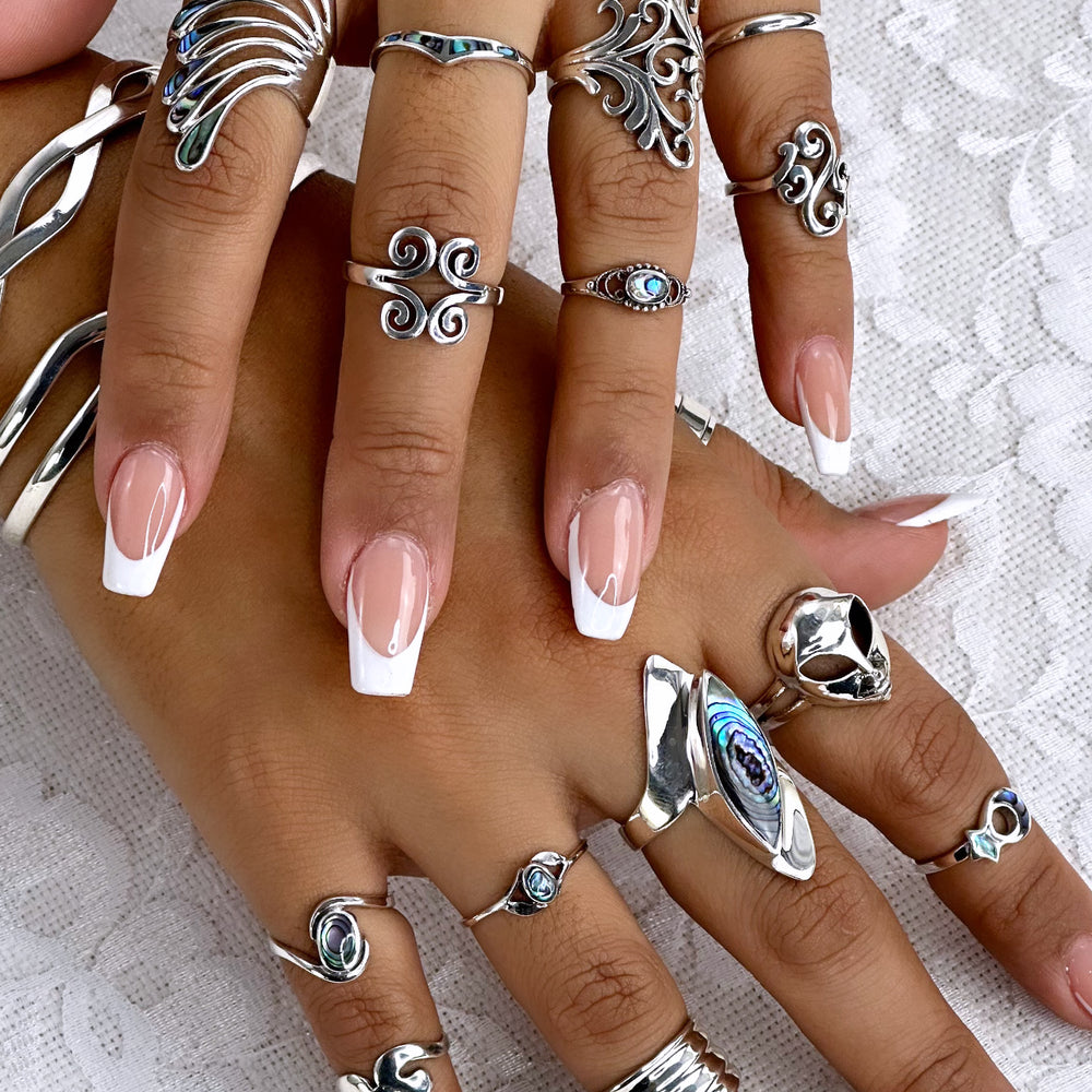 
                  
                    A woman's hands adorned with captivating rings, including the Beautiful Inlay Stone Wing Fan Ring.
                  
                