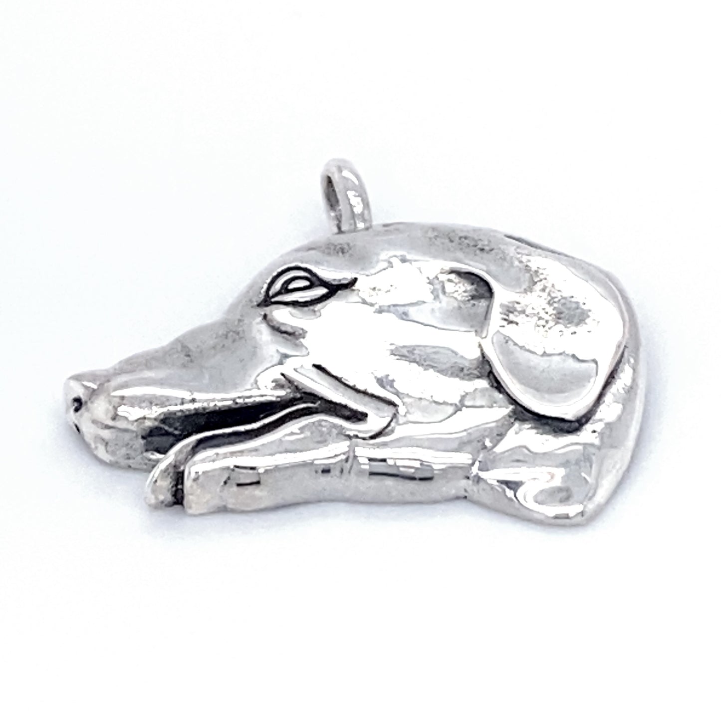 A Dog Head Pendant shaped like a dog's head, featuring a loop at the top for attaching to a necklace or chain. This beautiful dog charm makes an ideal dog lover gift.