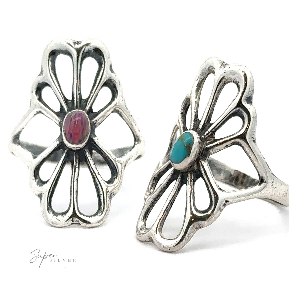 Two sterling silver American Made Flower Rings feature different gemstones in the center, one red and one blue, against a white background. Handcrafted in America, these exquisite pieces bear the brand name 