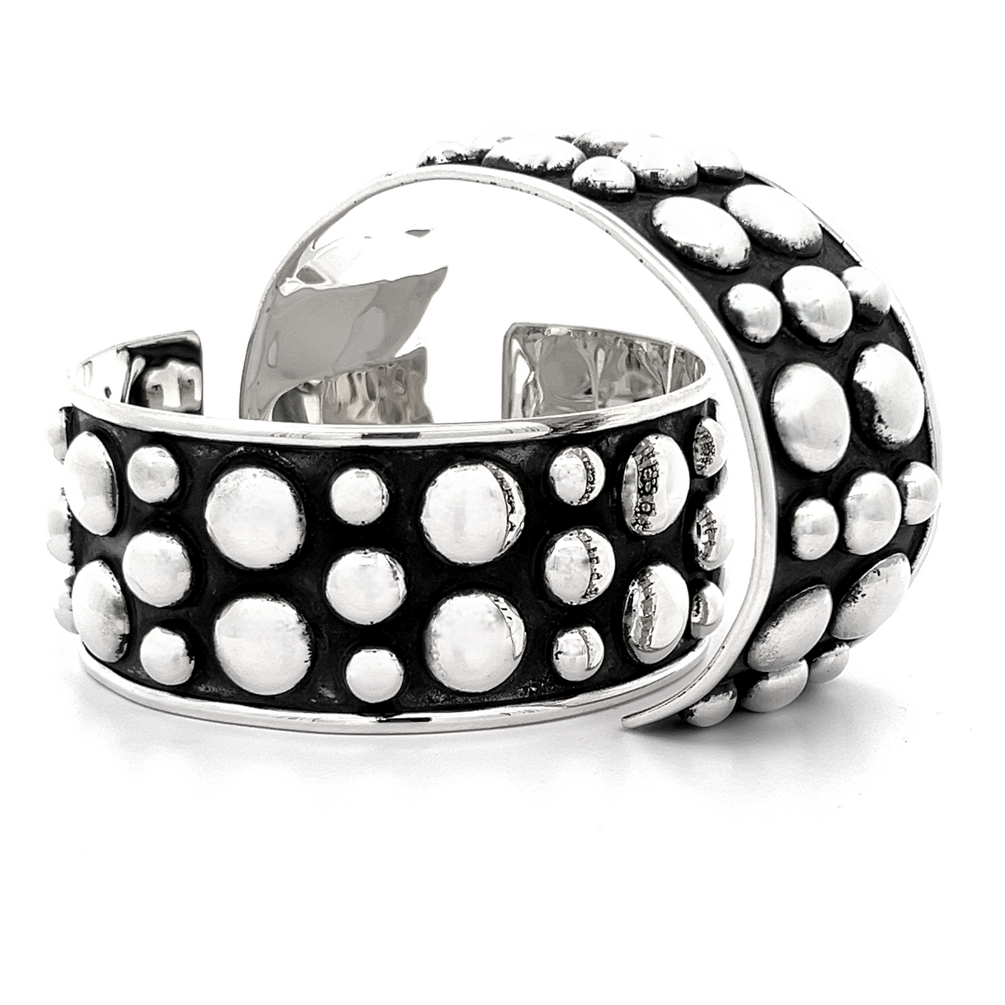 Close-up of the Unique Ball Studded Cuff set against a black background, highlighting its striking circular patterns. This bold cuff exudes a rebellious vibe, perfect for those who dare to stand out.