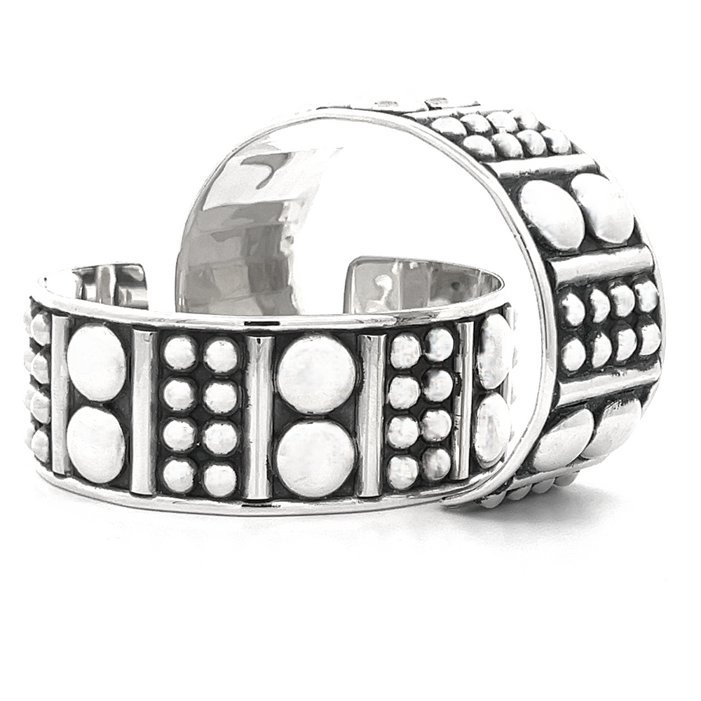 
                  
                    A pair of Bold Ball Patterned Cuffs featuring textured patterns with dots and lines, showcasing an edgy design.
                  
                