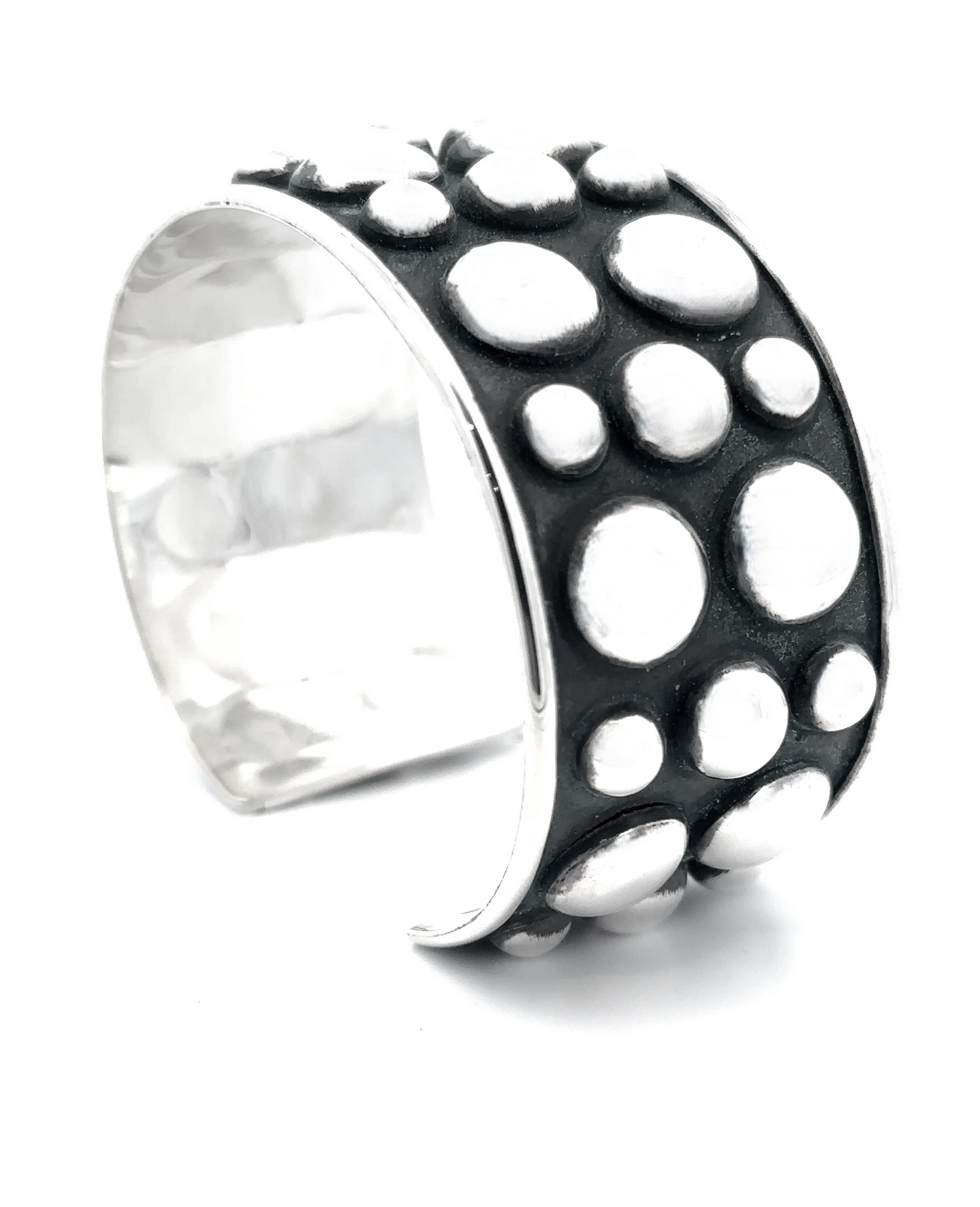 
                  
                    The Unique Ball Studded Cuff showcases a bold, rebellious design with raised bubble details on a contrasting black background, making it a true statement piece.
                  
                