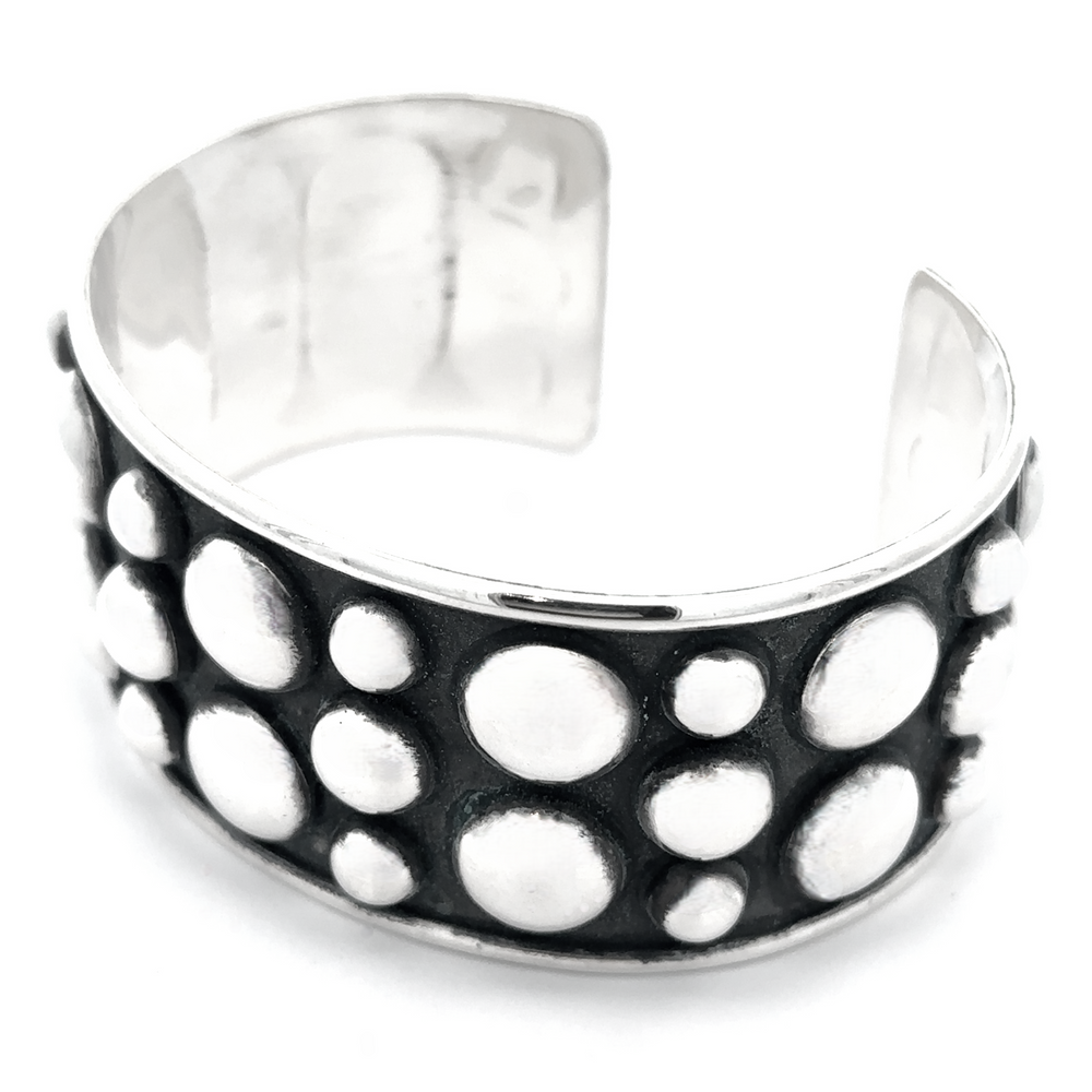 
                  
                    Unique Ball Studded Cuff with a striking design of raised circular dots on a dark background, emanating a rebellious vibe.
                  
                