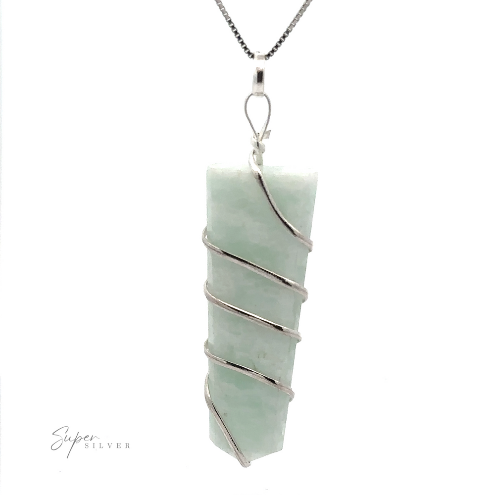 
                  
                    A Wire Wrapped Slab Pendant with a rectangular, light green stone slab, meticulously wrapped in silver wire, hangs from a thin silver chain. The background is white, and the text "Super Silver" is printed at the bottom left. This exquisite piece of gemstone jewelry makes a subtle yet standout statement.
                  
                