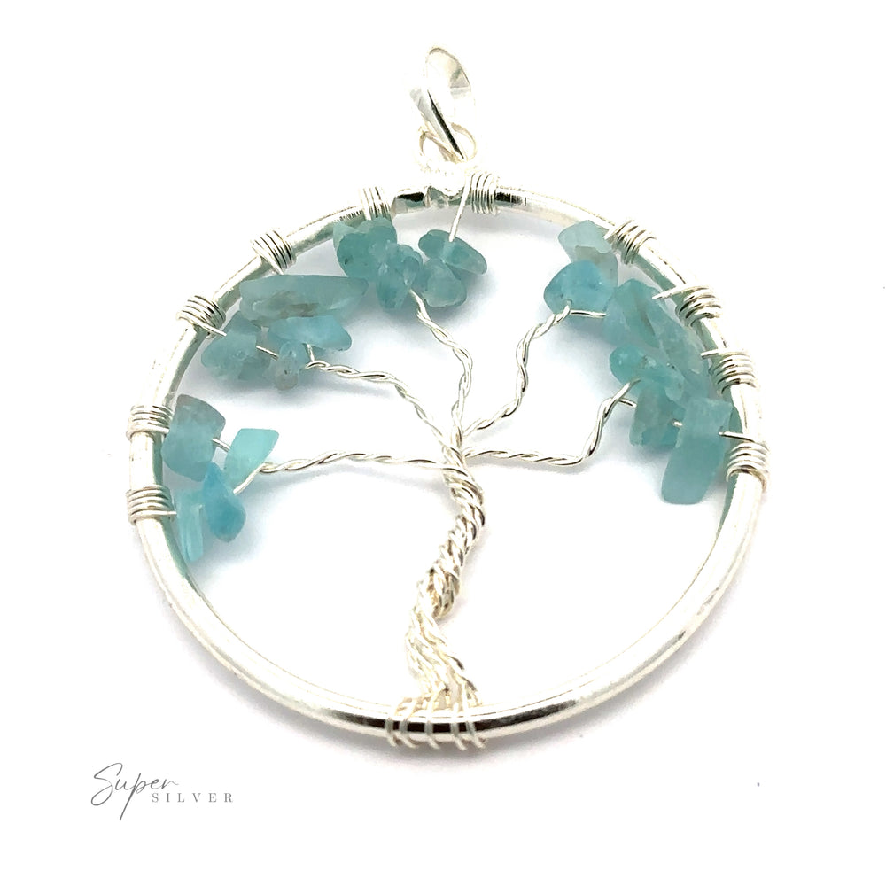 
                  
                    A stunning Wire Wrapped Tree of Life Pendant with Stones featuring a wire-wrapped tree adorned with light blue gemstone chips as leaves, all set within a circular silver frame.
                  
                