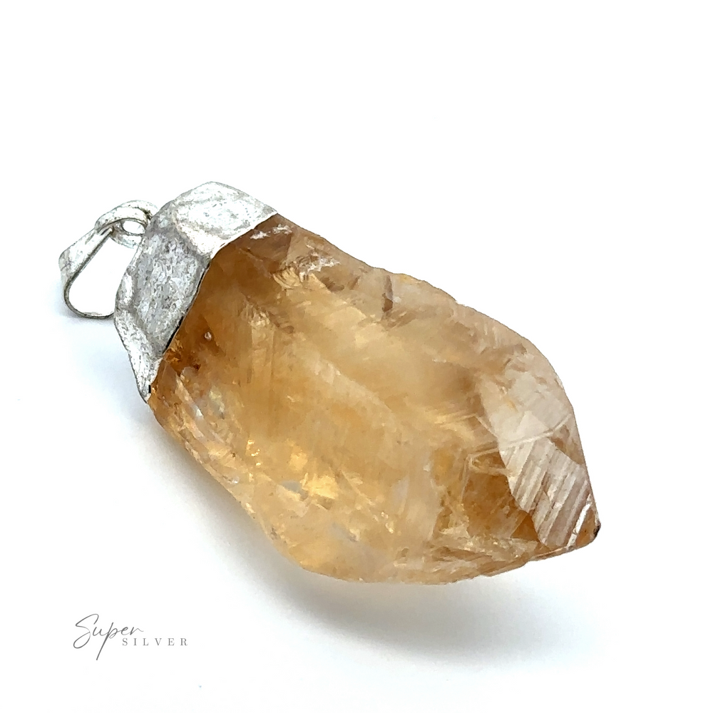 
                  
                    A Raw Crystal Pendant With Silver Cap featuring a yellowish-brown raw crystal encased in a silver setting with a loop for attaching to a necklace.
                  
                
