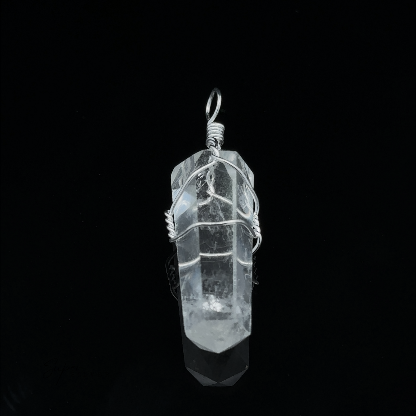 
                  
                    A Wire Wrapped Stone Pendant sits elegantly against a black background.
                  
                