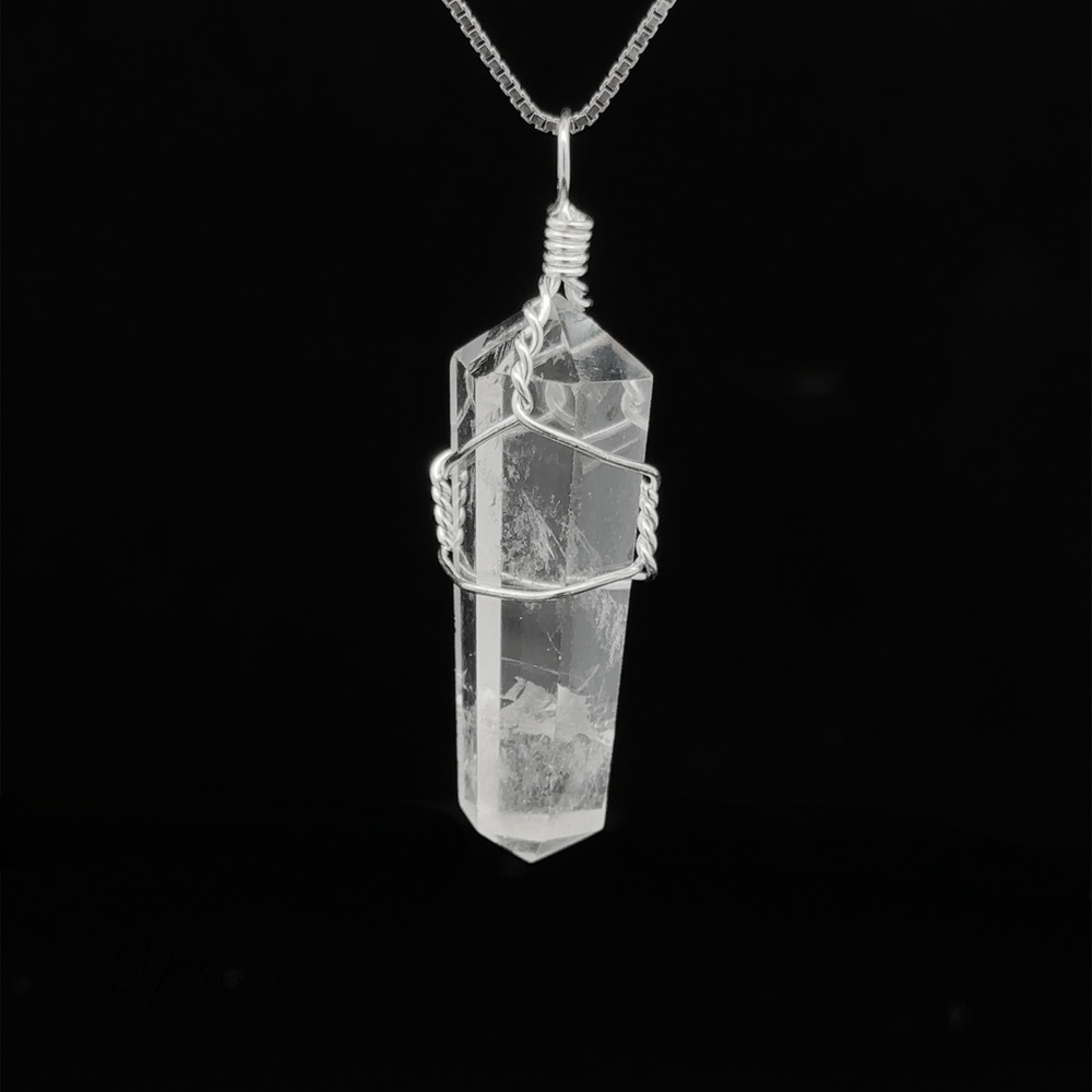 
                  
                    A Wire Wrapped Stone Pendant hangs elegantly from a silver chain against a black background.
                  
                
