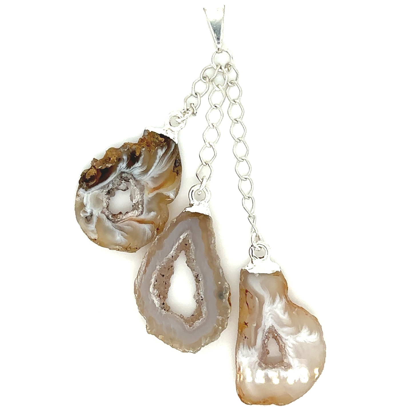 A trio of Super Silver crystal geode pendant agate pendants on a chain, showcasing their natural beauty in an earthy style.