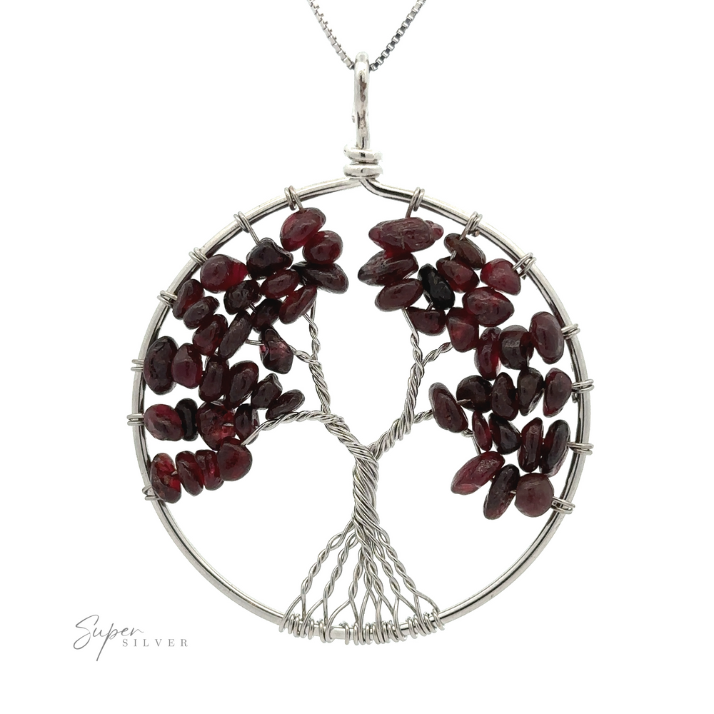 
                  
                    A circular silver Wire Wrapped Tree of Life Pendant featuring branches adorned with dark red gemstones. The pendant hangs on a silver chain, and "Super Silver" text is visible in the bottom left corner.
                  
                