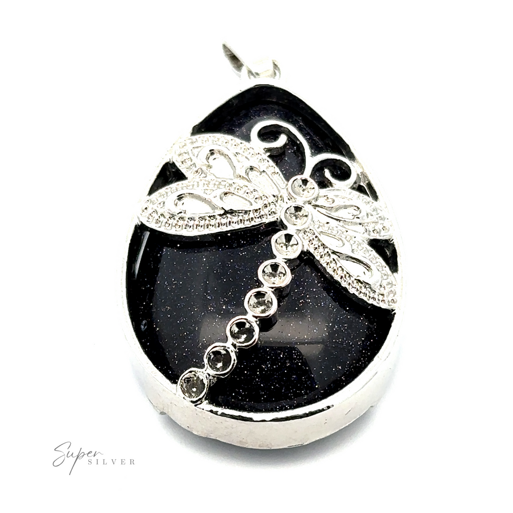 
                  
                    Teardrop Stone pendant with Dragonfly featuring a black stone, decorative silver dragonfly with detailed wings and body encrusted with small clear stones, set in a mixed metals frame.
                  
                