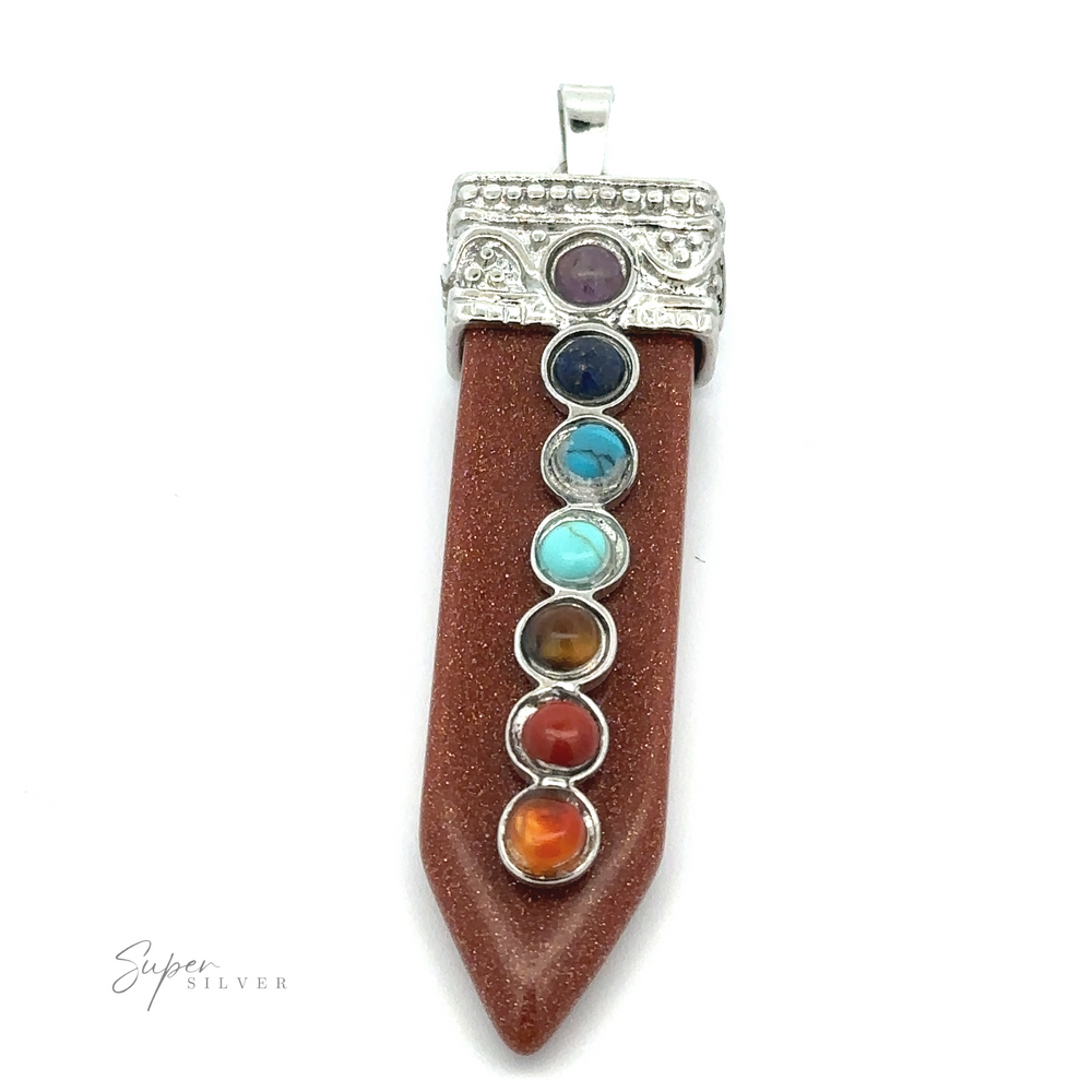 
                  
                    A pendant with a brown, pointed stone resembling an obelisk and seven colorful chakra stones arranged vertically in a silver-plated design is the Obelisk Crystal Pendant with Small Chakra Stones.
                  
                
