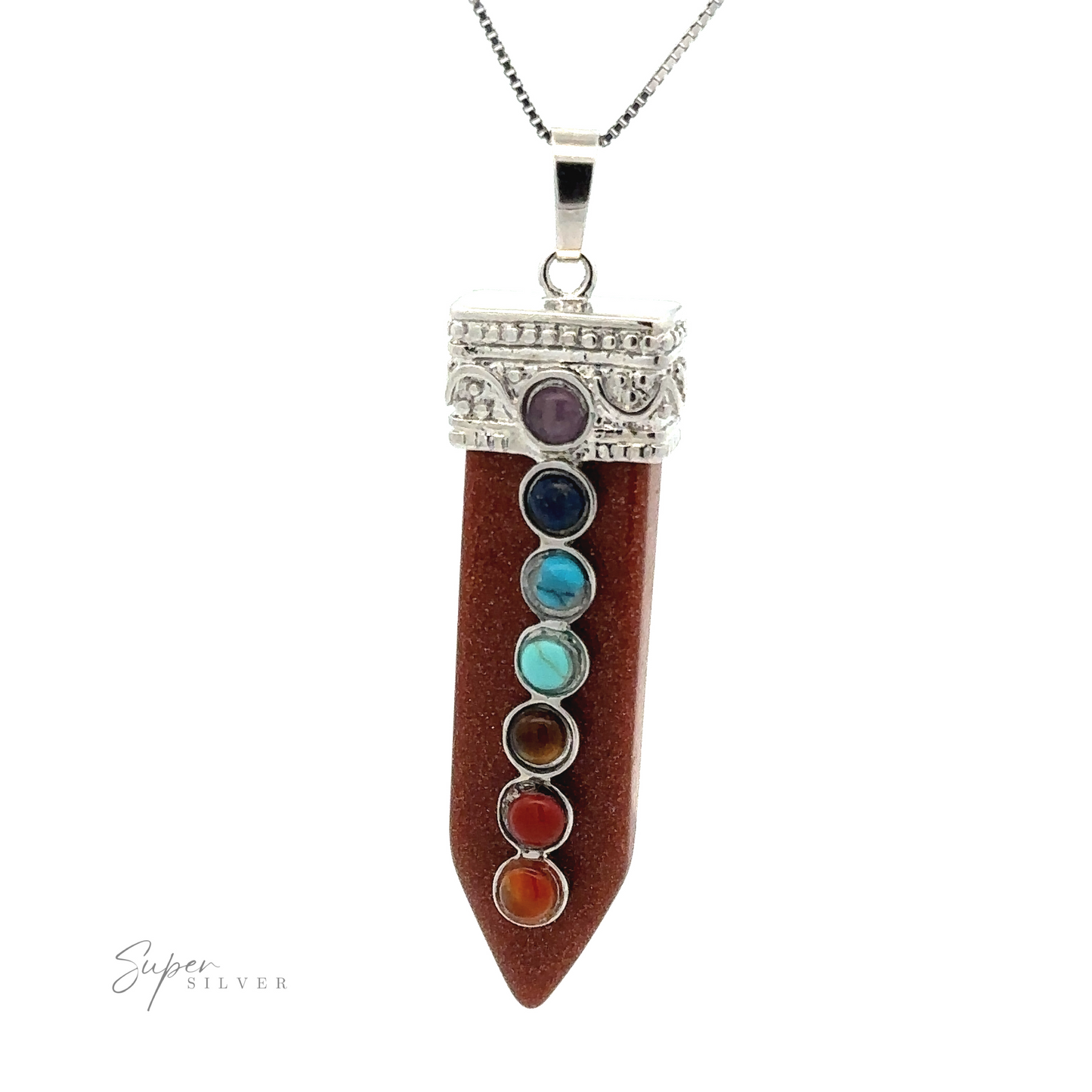 
                  
                    Obelisk Crystal Pendant with Small Chakra Stones featuring a brown stone and accented with seven smaller multicolored chakra stones arranged vertically. The pendant has intricate metalwork at the top.
                  
                