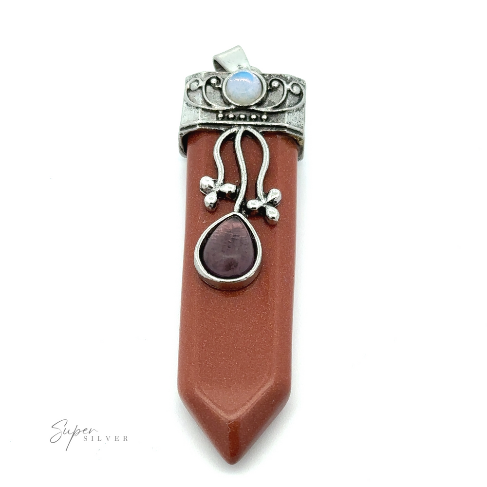 
                  
                    The Obelisk Crystal Stone Pendant features a reddish-brown pointed stone, a small amethyst jewel, and a decorative silver cap adorned with an opalite blue stone.
                  
                