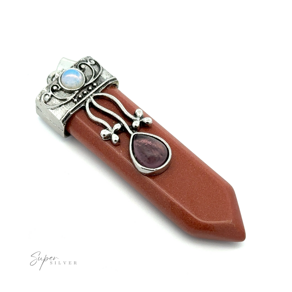 
                  
                    A polished reddish-brown Obelisk Crystal Stone Pendant with silver detailing, featuring two gemstones—one blue Opalite and one purple Amethyst.
                  
                